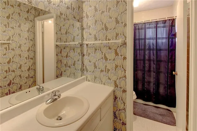 a white toilet sitting next to a bathroom sink
