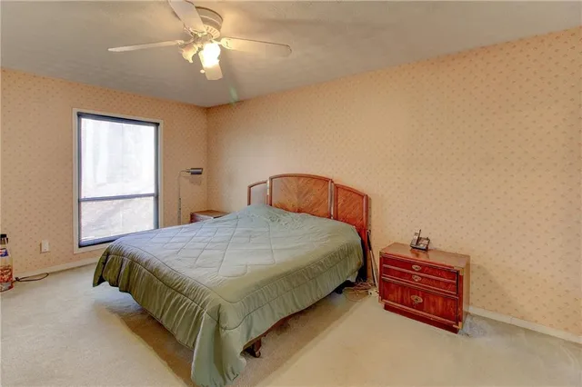 a bedroom with a large bed and a chandelier