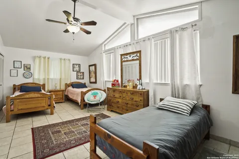 a bedroom with furniture and a chandelier