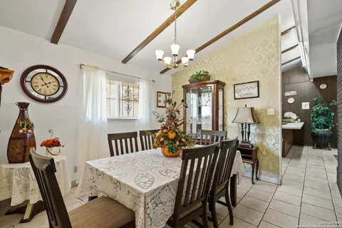 a view of a dining room with furniture and chandelier