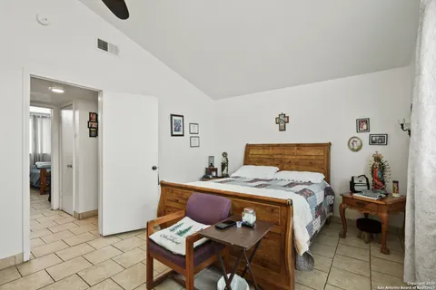 a bedroom with a bed and chair