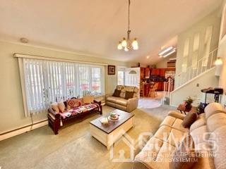 57 Eardley Road Edison, NJ 08817 - Photo 15 of 33 a living room with furniture and a chandelier