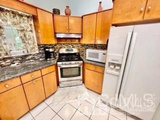 57 Eardley Road Edison, NJ 08817 - Photo 20 of 33 a kitchen with stainless steel appliances granite countertop a stove a sink and a refrigerator