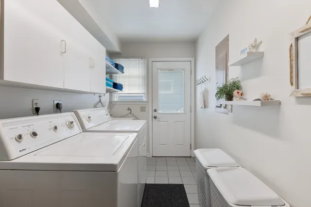 a hallway with a washer and dryer