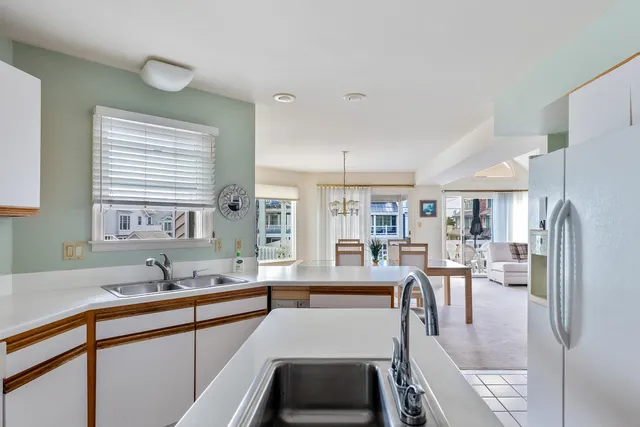 a kitchen with counter top space a sink cabinets and appliances