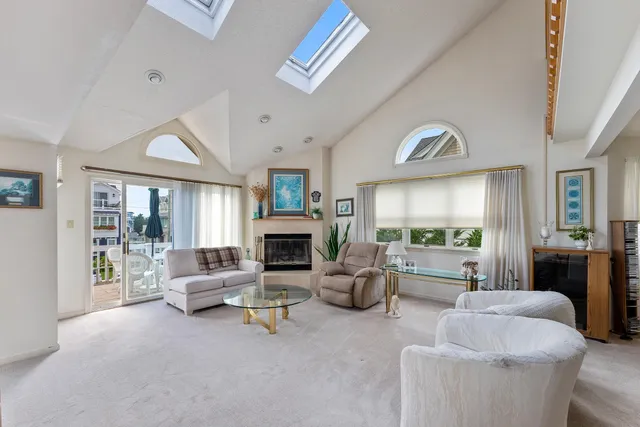 a living room with furniture a fireplace and a large window