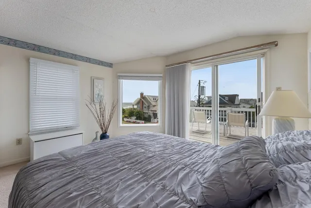 a bedroom with a large bed and a large window