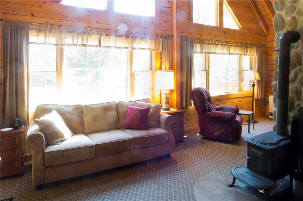 5 North Shore Road Brownville, ME 04414 - Photo 7 of 25 Living room has a lot of glass to...