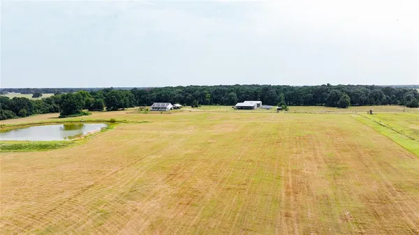 an aerial view of ocean with residential house and outdoor space