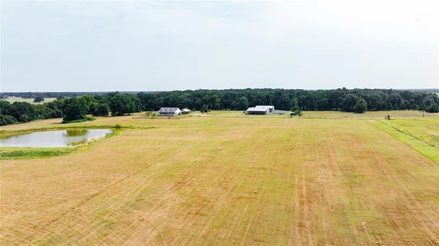 an aerial view of ocean with residential house and outdoor space