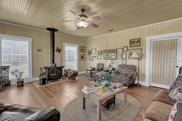 a living room with furniture kitchen view and a chandelier