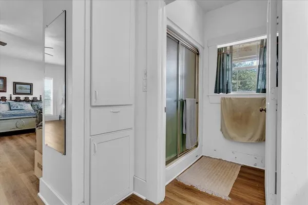 a bedroom with a bed and a large window