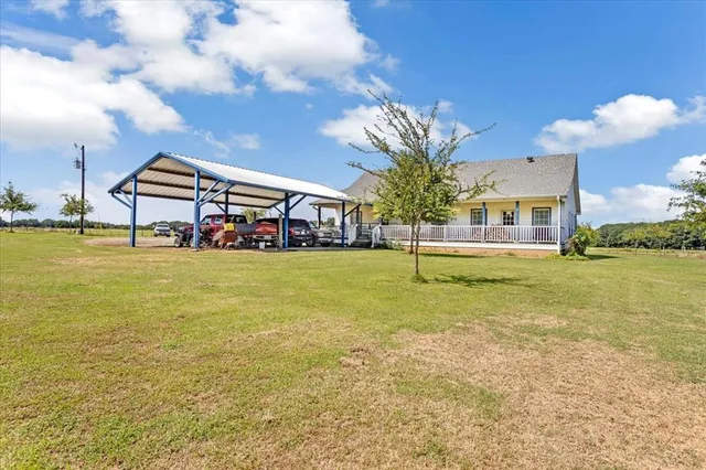 a house view with swimming pool in front of it