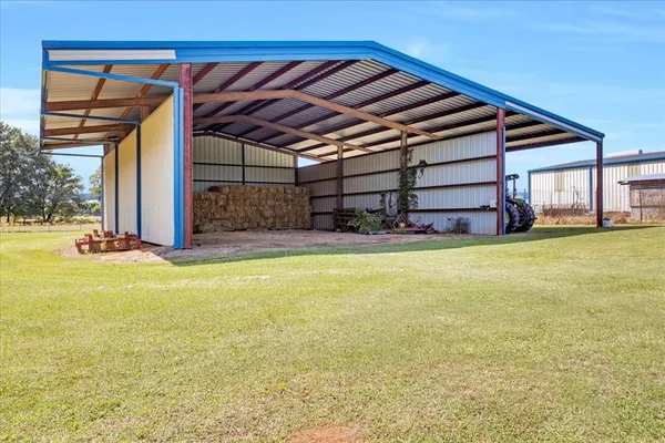 a swimming pool with yard in front of it