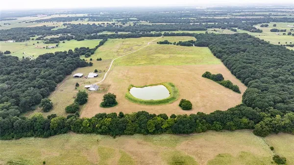 an aerial view of residential houses with outdoor space and river