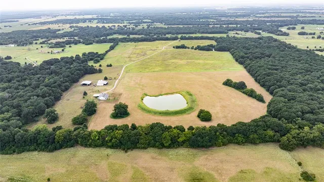 an aerial view of residential houses with outdoor space and river