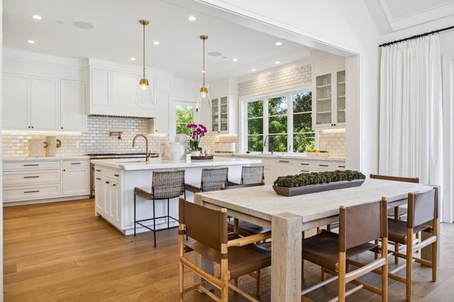 a living room with furniture a fireplace and a large window