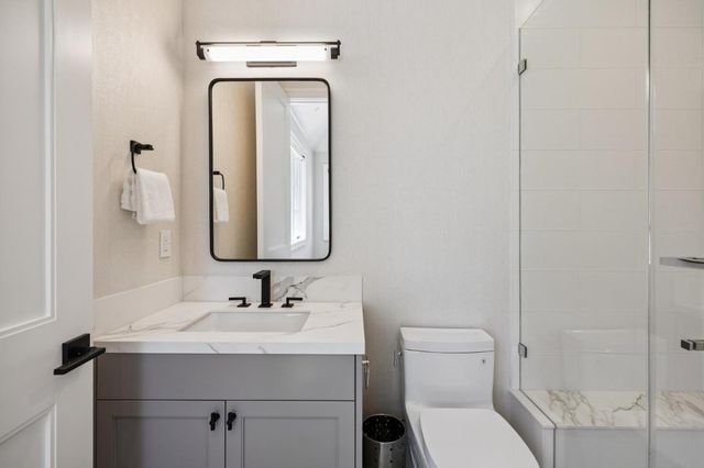 an aerial view of residential houses with outdoor space and trees