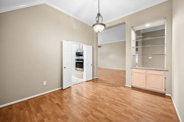 a view of an empty room with a kitchen