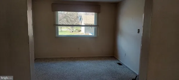 a view of an empty room with a fireplace