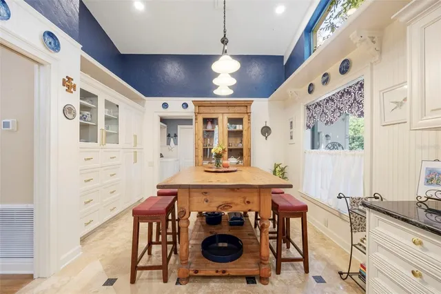 a bathroom with a granite countertop sink mirror vanity and toilet