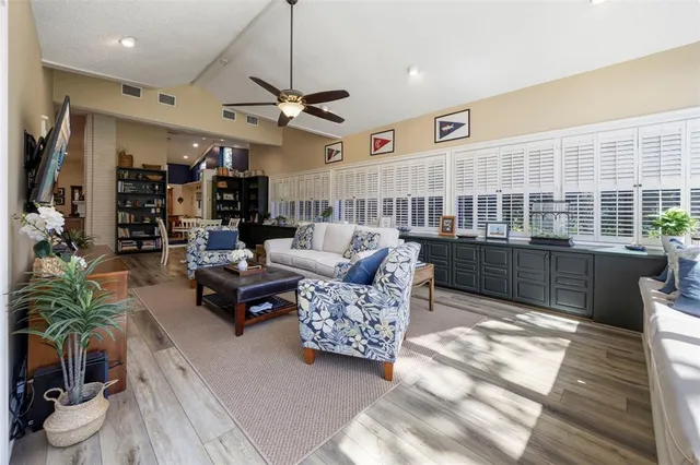 a living room with furniture and a floor to ceiling window