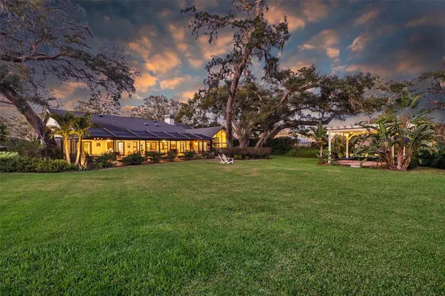 a living room with furniture a rug and a chandelier
