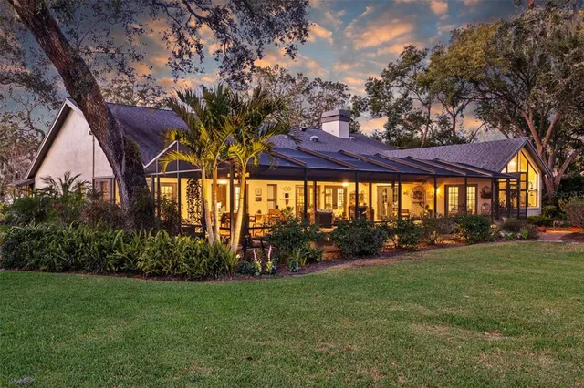 a living room with furniture and a dining table with kitchen view