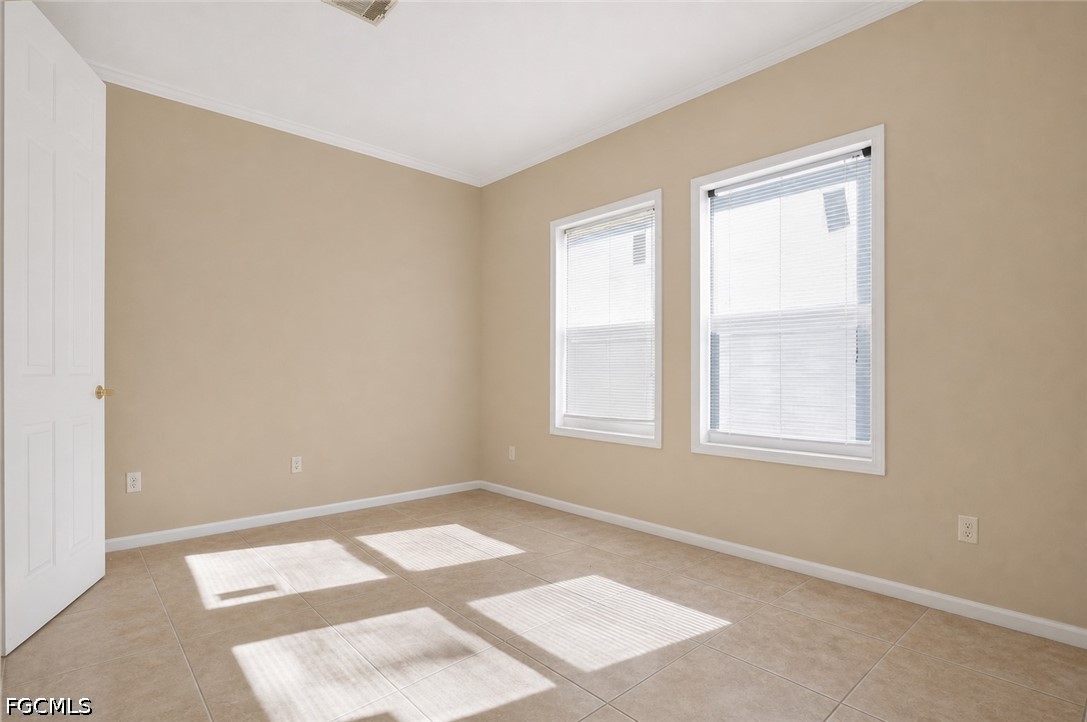 2808 34th Street Southwest Lehigh Acres, FL 33976 - Photo 9 of 14 an empty room with a window