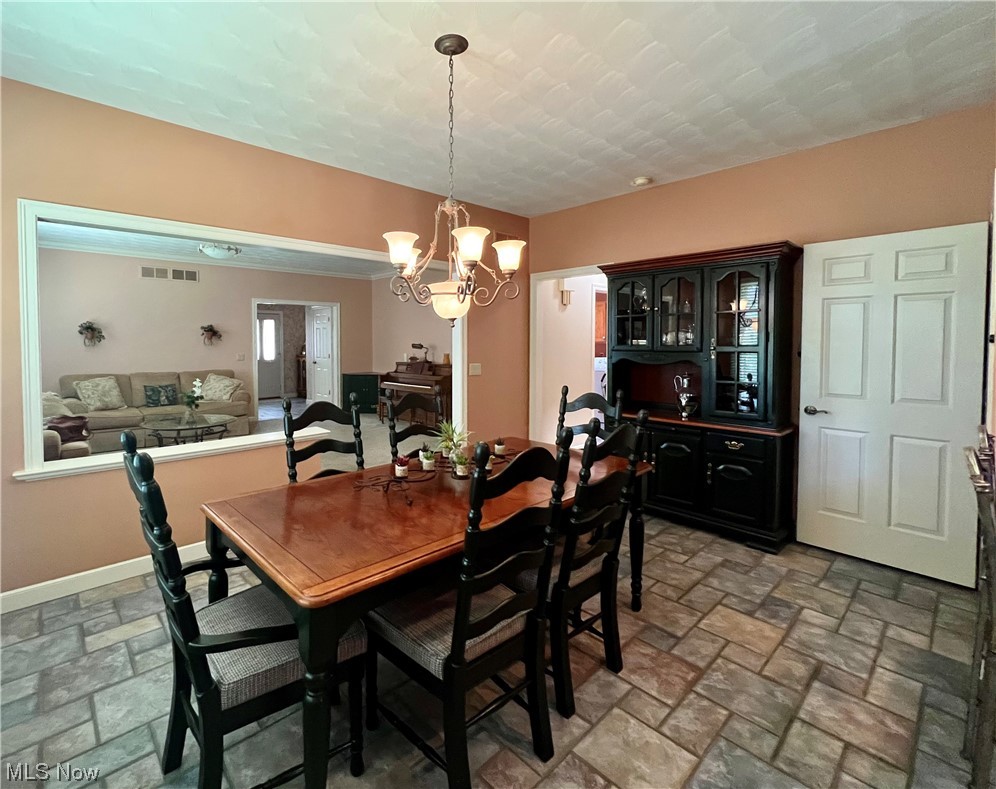 185 B Mathews Road Youngstown, OH 44512 - Photo 11 of 35 Tiled dining area with a notable chandelier