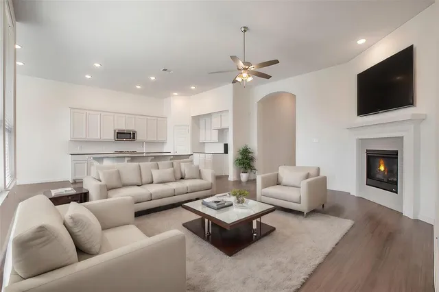 a living room with furniture fireplace and flat screen tv