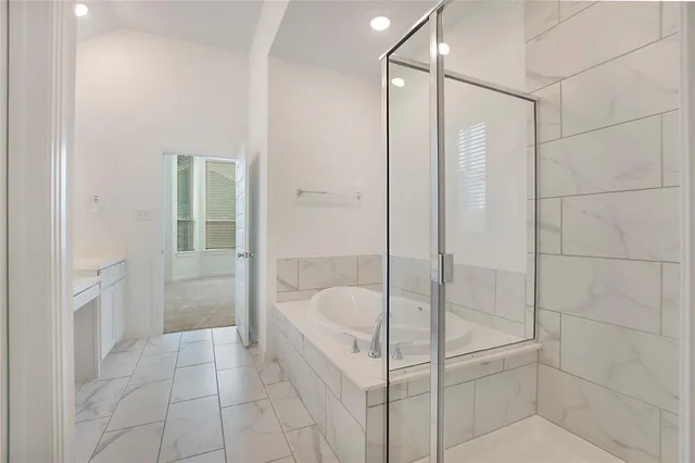 a bathroom with a bathtub and shower