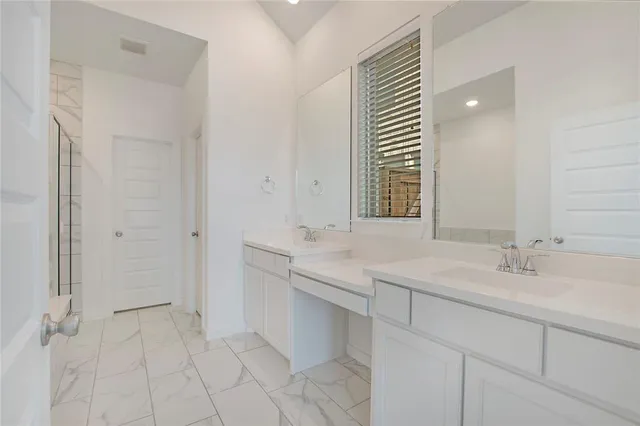 a bathroom with a sink double vanity and a mirror