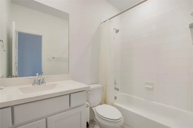 a bathroom with a sink toilet vanity and shower
