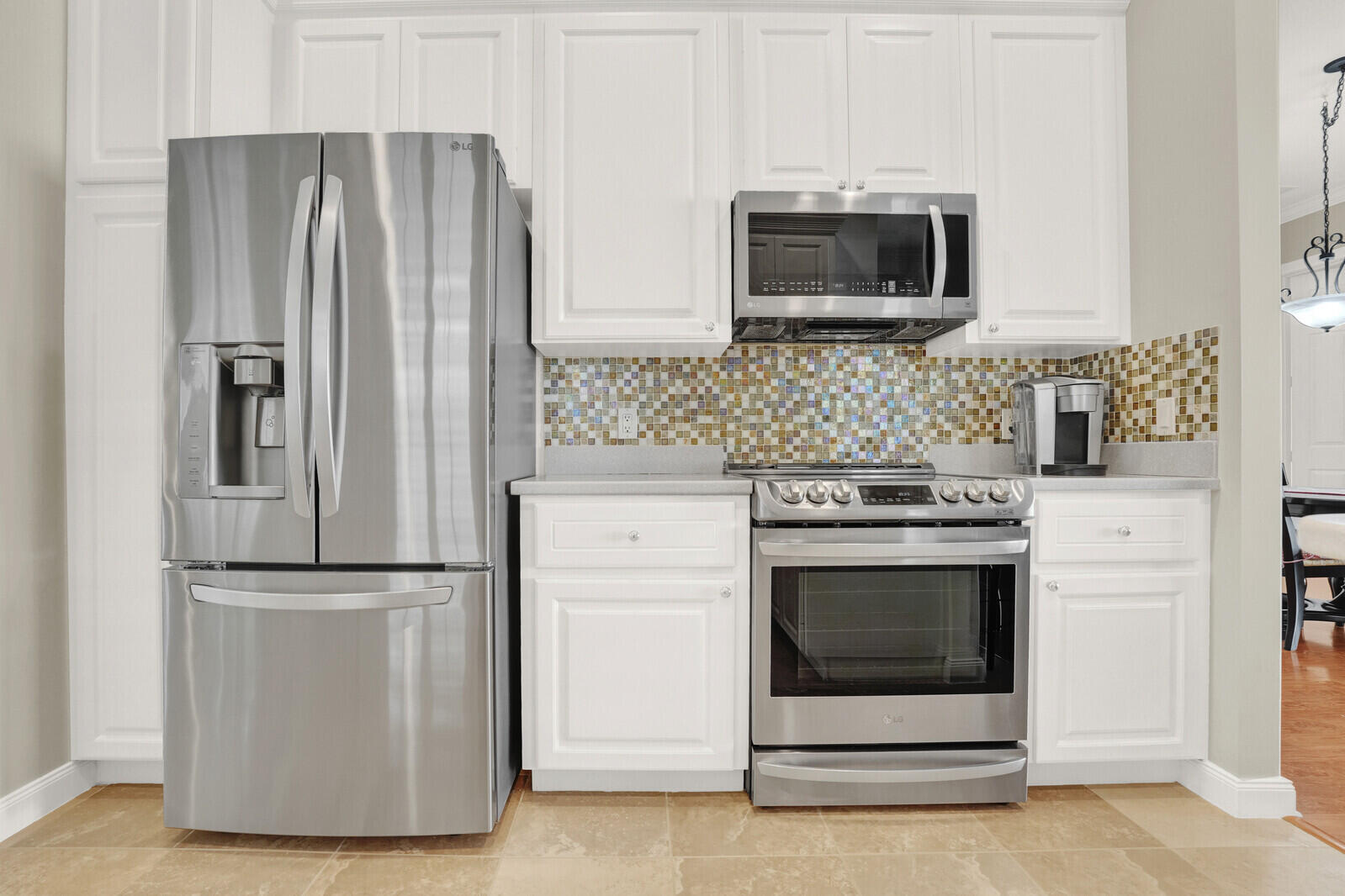 2688 East Community Drive Jupiter, FL 33458 - Photo 15 of 50 a kitchen with cabinets stainless steel appliances and wooden floor