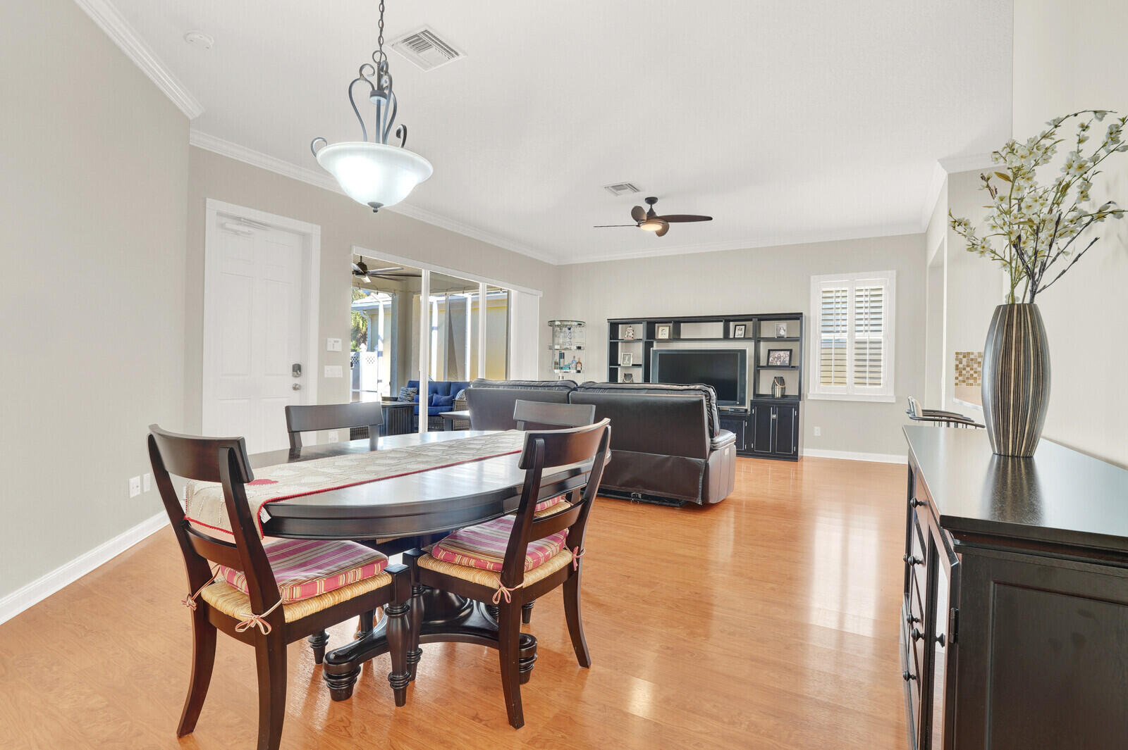 2688 East Community Drive Jupiter, FL 33458 - Photo 22 of 50 a view of a dining room with furniture window and wooden floor