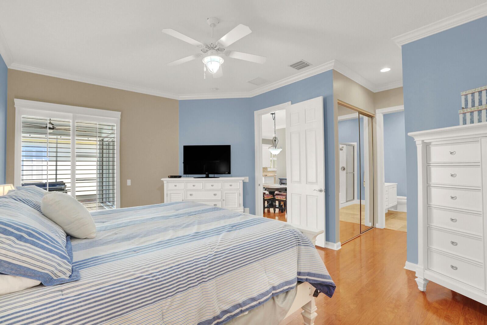 2688 East Community Drive Jupiter, FL 33458 - Photo 25 of 50 a spacious bedroom with a bed and a television