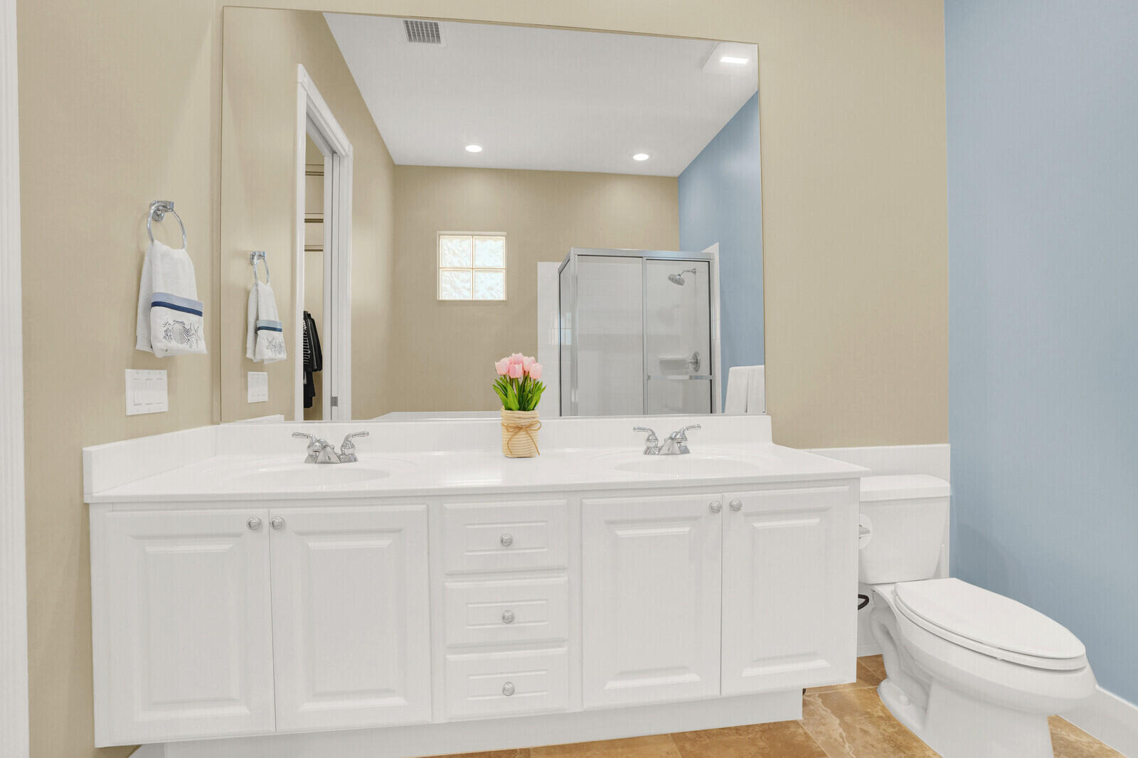 2688 East Community Drive Jupiter, FL 33458 - Photo 29 of 50 a bathroom with a sink a toilet a mirror and vanity