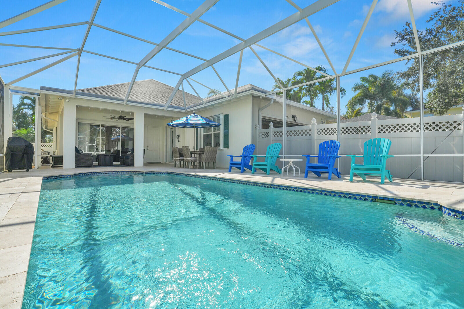 2688 East Community Drive Jupiter, FL 33458 - Photo 40 of 50 a view of a house with a backyard and a patio