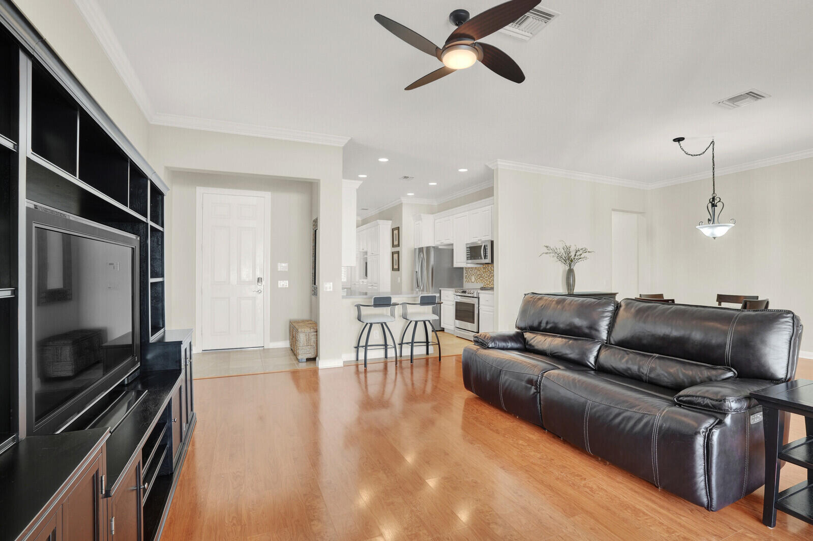 2688 East Community Drive Jupiter, FL 33458 - Photo 10 of 50 a living room with furniture and a flat screen tv