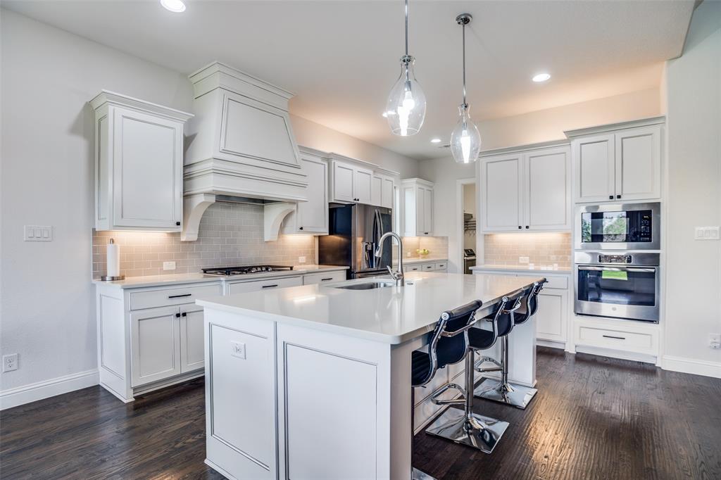 1011 Riviera Road Roanoke, TX 76262 - Photo 4 of 28 Bright kitchen with abundant cabinetry and pendant lighting
