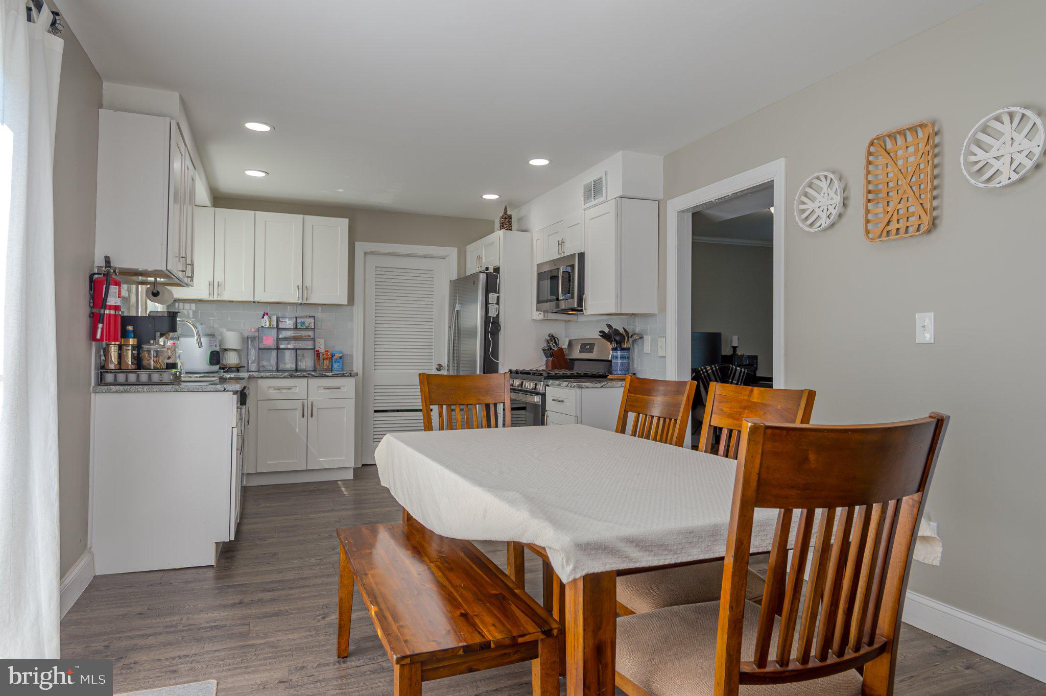 60 Midvale Lane Willingboro, NJ 08046 - Photo 7 of 24 a kitchen with a table chairs refrigerator and microwave
