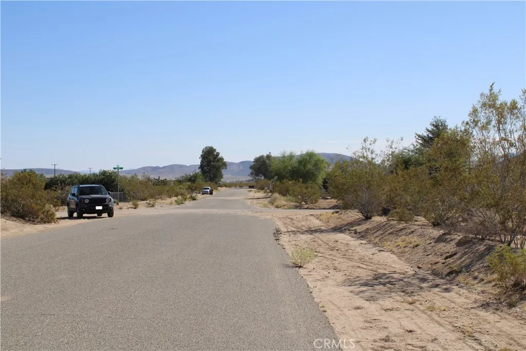 63480 Walpi Joshua Tree, CA 92252 - Photo 7 of 13 a view of a road with a building in the background