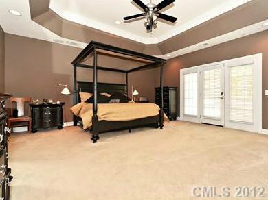 16621 Turtle Point Road Charlotte, NC 28278 - Photo 10 of 16 a bedroom with a bed ceiling fan and a large window