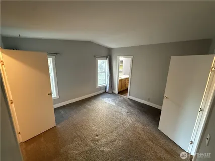 a spacious bathroom with a double vanity sink a mirror and a toilet