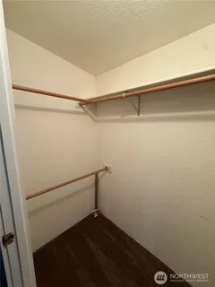 a spacious bathroom with a toilet sink and mirror