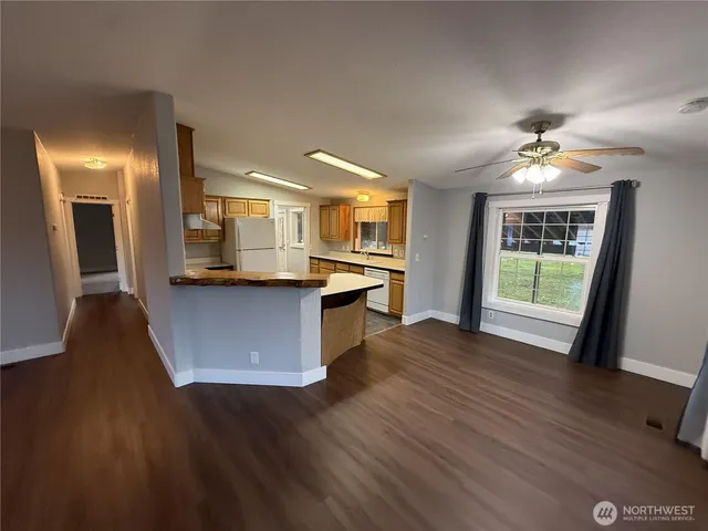 a view of kitchen with sink and refrigerator
