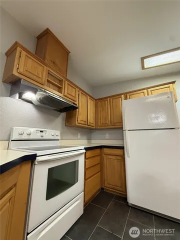 a kitchen with cabinets and white appliances