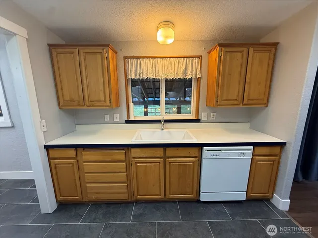 a kitchen with a sink and a cabinet