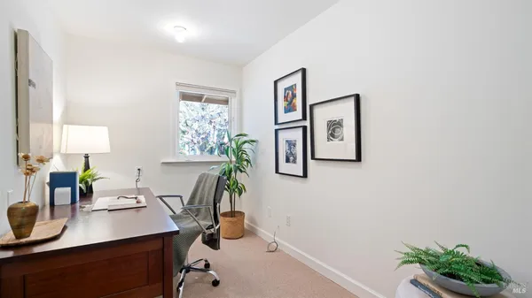 a spacious bedroom with a bed and a large window
